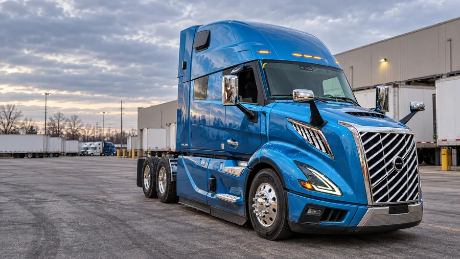 Blue Volvo tractor at a freight terminal